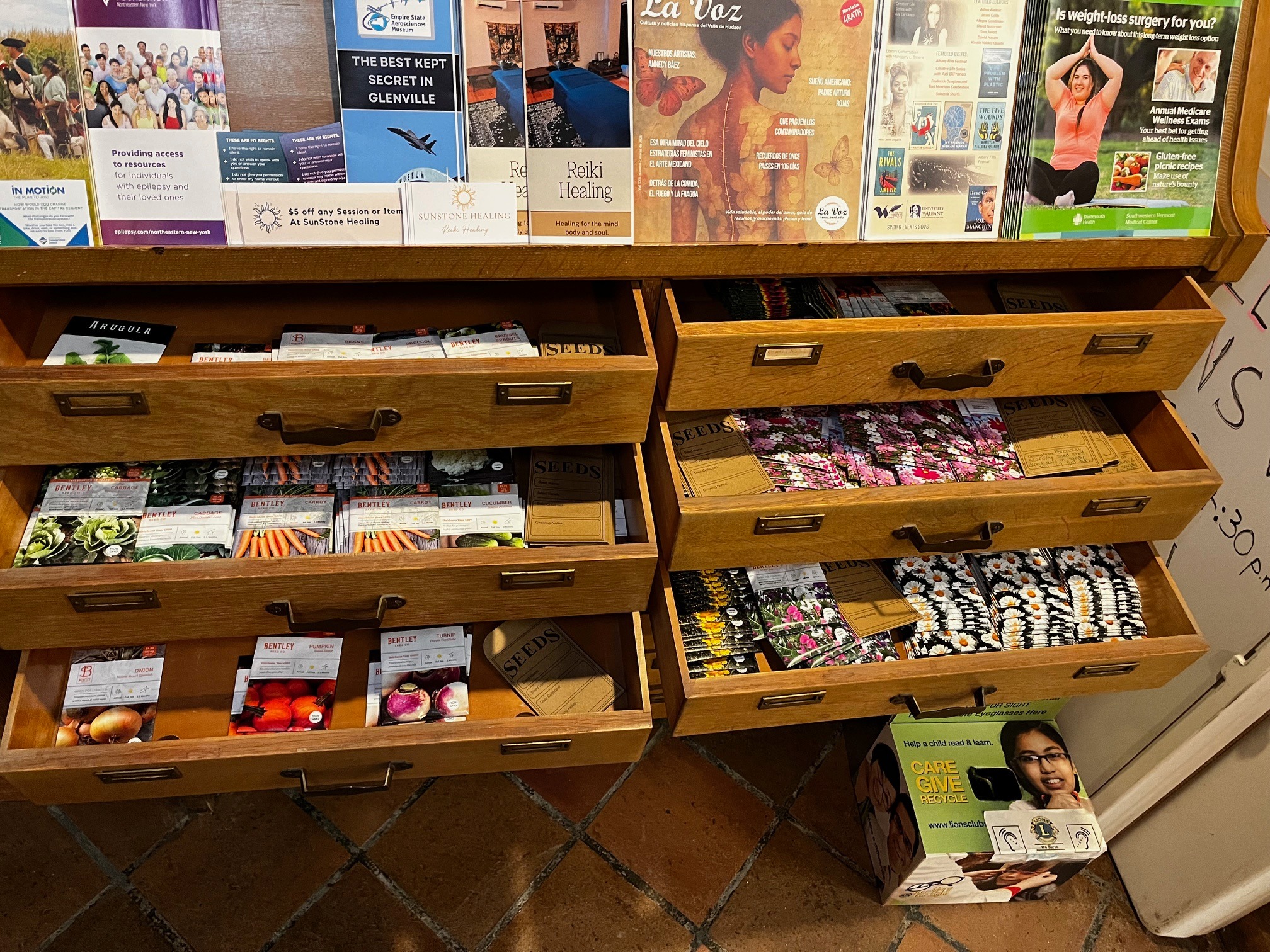 Open seed library drawers filled with packets of vegetables, flowers, and herbs at the Hoosick Falls seed library